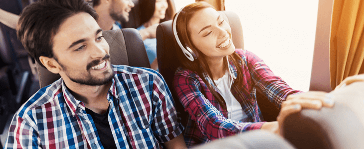 two friends sitting on a charter bus