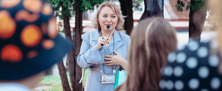 a female tour guide talking to a tour group