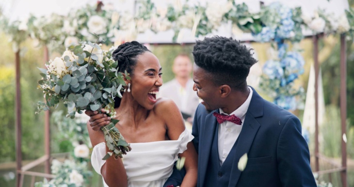 Bride and groom smiling at each other 