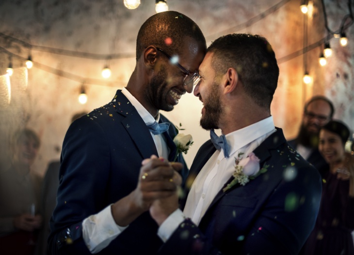 Two grooms dancing