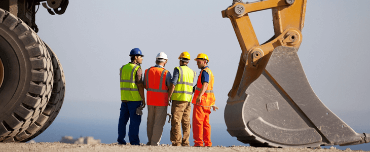 a crew of four workers look out at an empty space