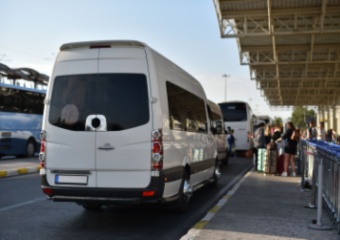 the back of a plain white airport shuttle